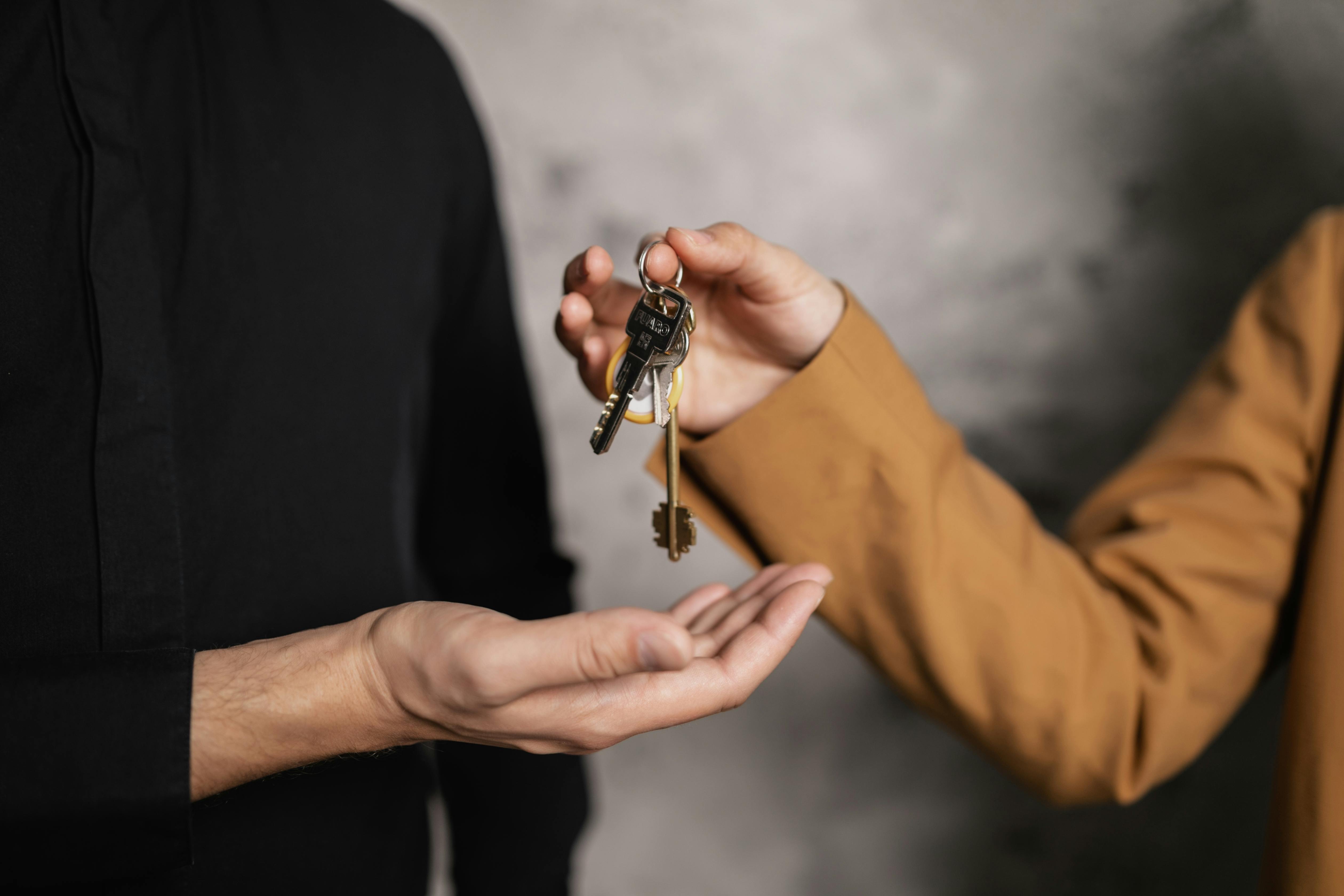 A buyer receiving house keys, illustrating the money and documents that have to be ready at closing.