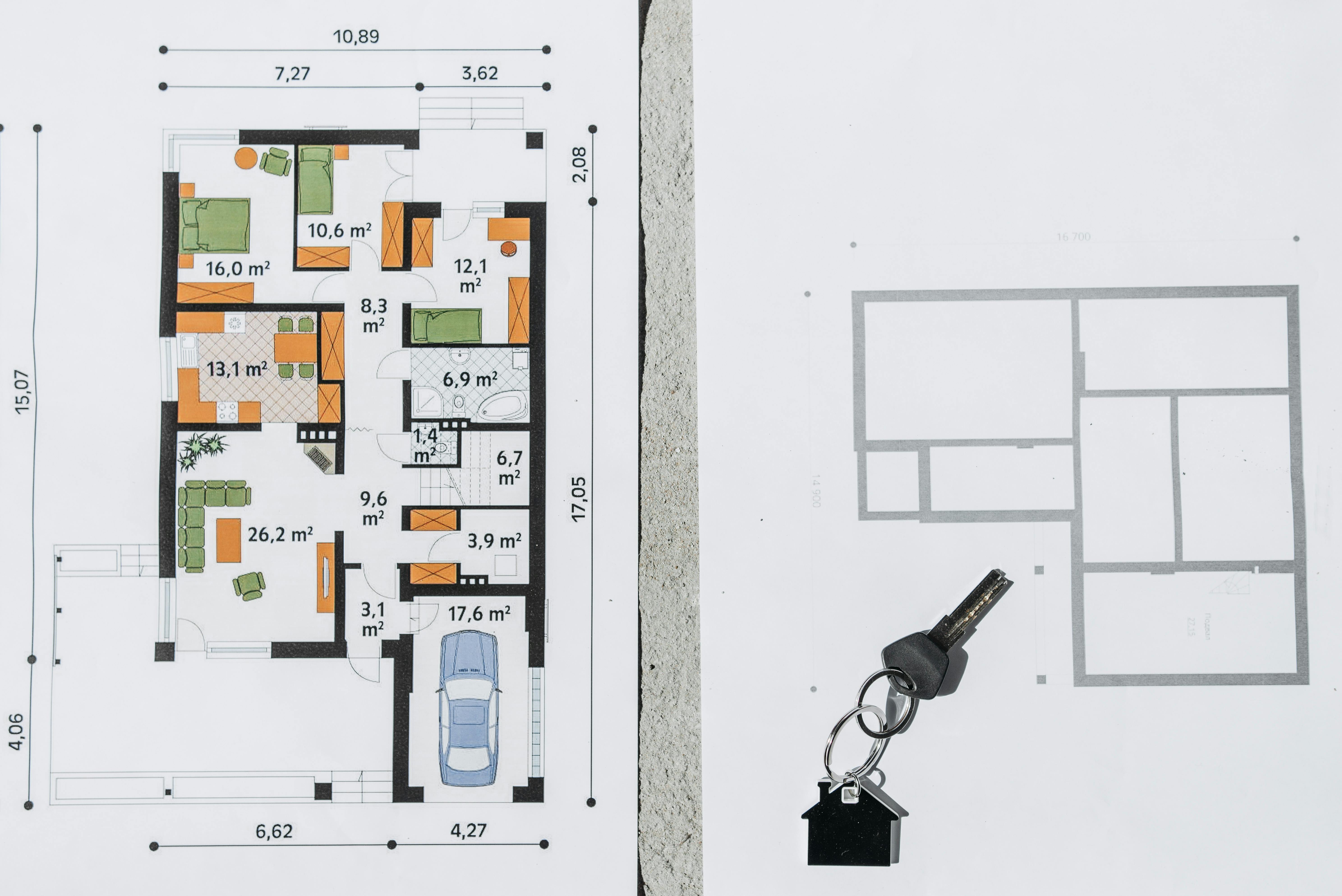 Paperwork, sketches, and project tools on a table, illustrating line-item planning before closing.