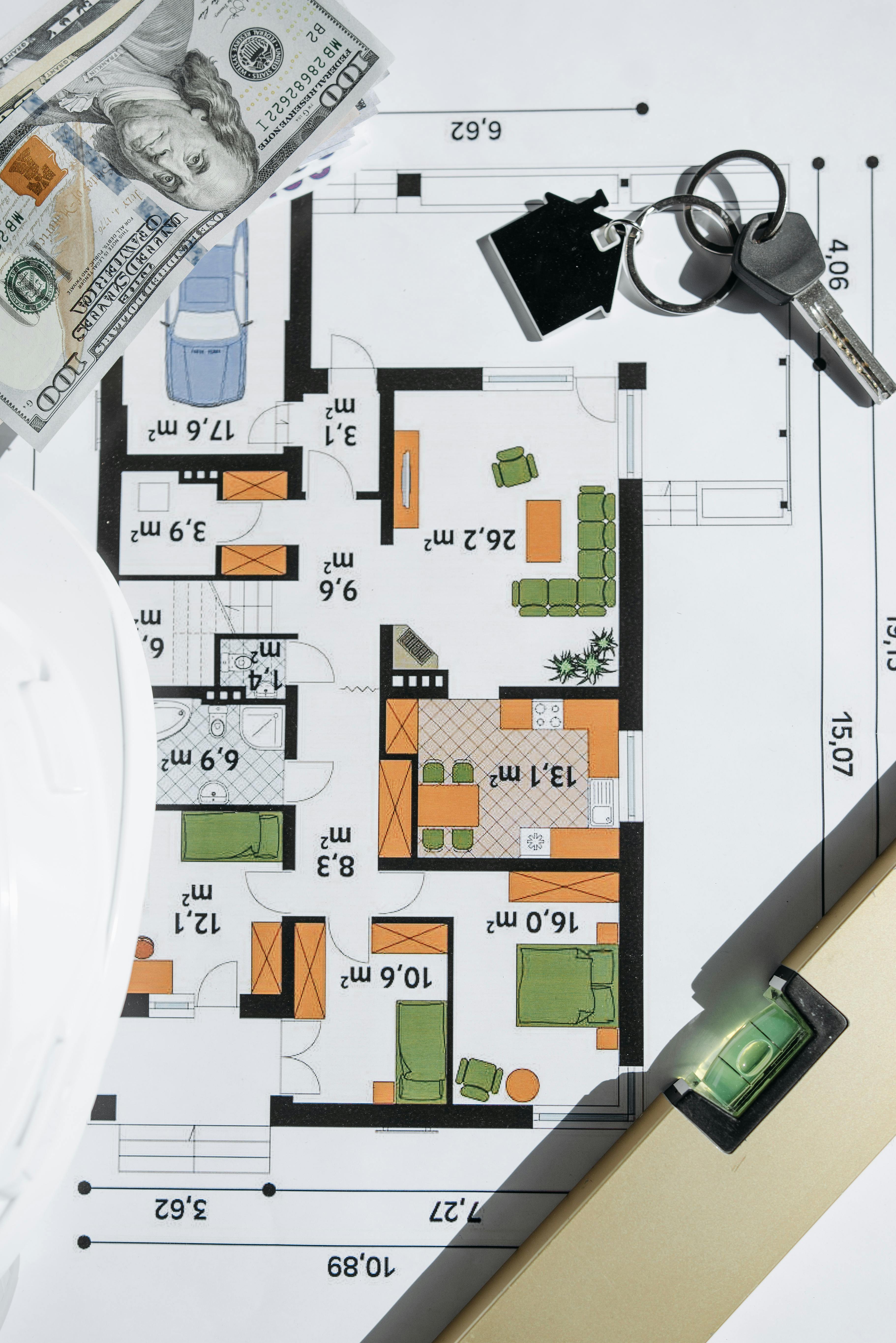 Cash and house keys on a home plan, illustrating settlement cash and post-closing reserve planning together.