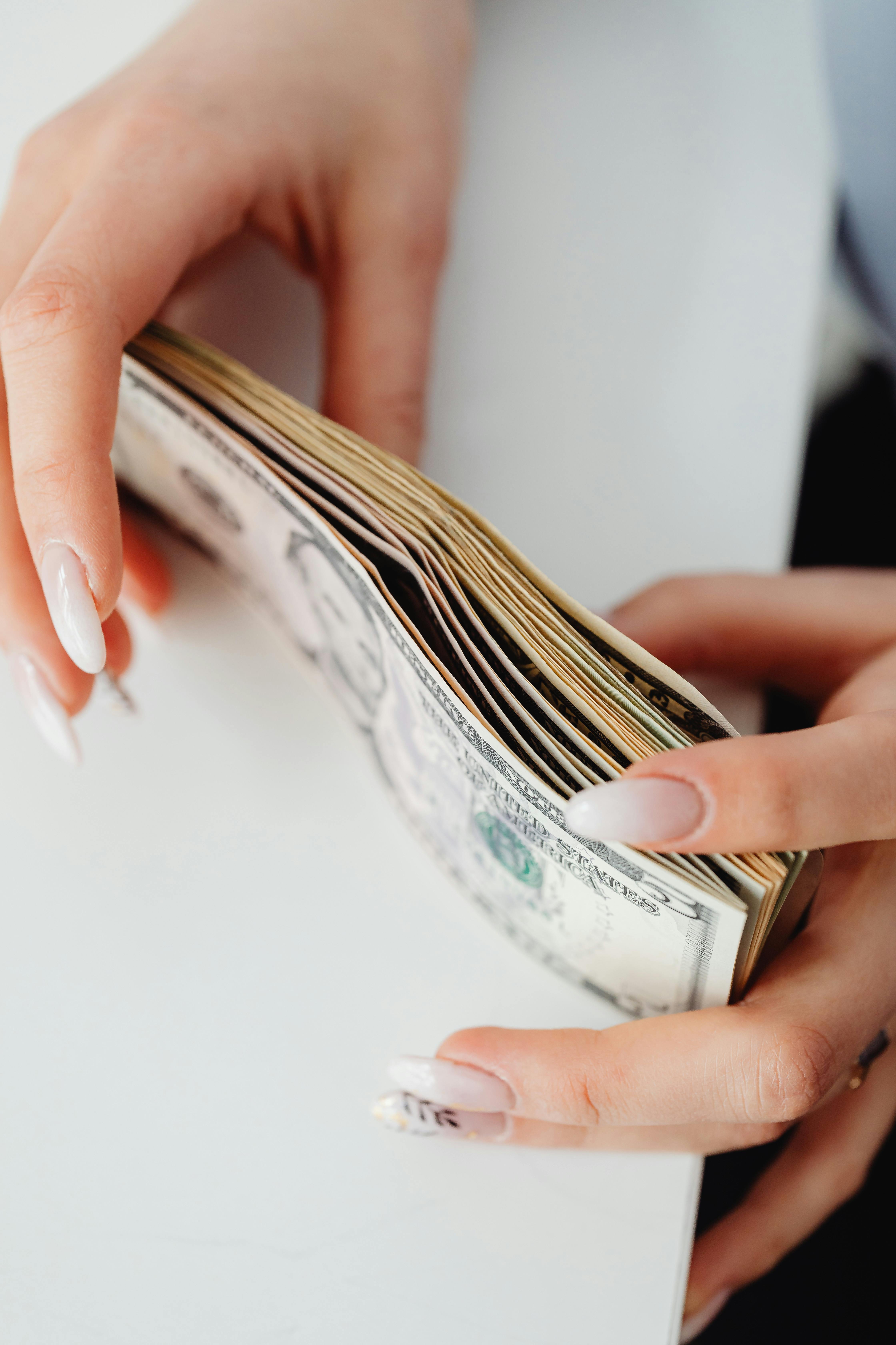 A person reviewing bills and a calculator while planning a home budget, illustrating the full monthly payment stack.